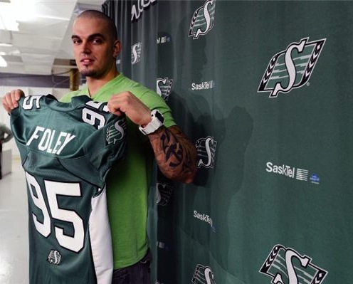 DL Ricky Foley poses for a photo with his new #95 Green and White Roughriders jersey. 